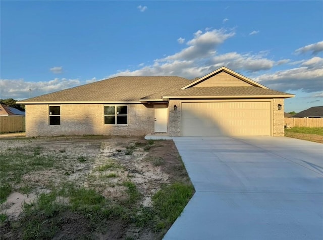 102 Meadow Dr, Dardanelle, AR 72834 - single story home featuring brick siding, a garage, driveway, and fence