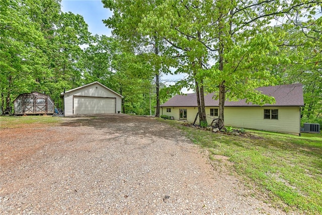 17155 Deer Park Ln, Pea Ridge, AR 72751 - ranch-style house featuring an outdoor structure, a garage, central air condition unit, and a storage shed