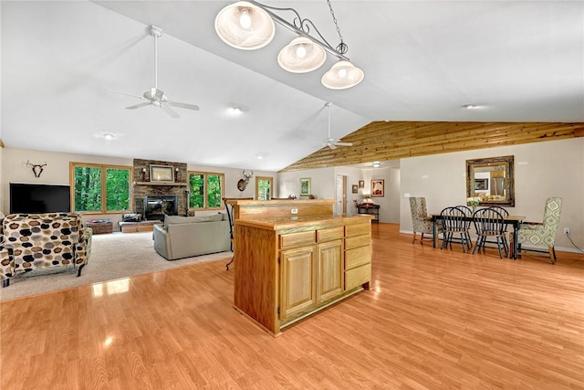 17155 Deer Park Ln, Pea Ridge, AR 72751 - kitchen with a ceiling fan, vaulted ceiling, light wood-style floors, a fireplace, and open floor plan