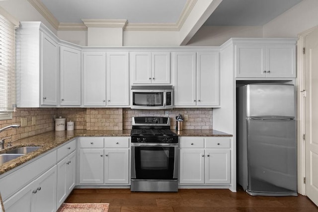 2636 Everest Ave, Rogers, AR 72758 - kitchen with stainless steel appliances, white cabinets, dark stone counters, a sink, and crown molding