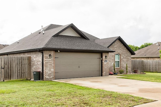 view of front facade featuring brick siding, a garage, a shingled roof, and driveway