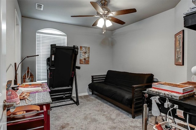 living room featuring ceiling fan, carpet, and baseboards