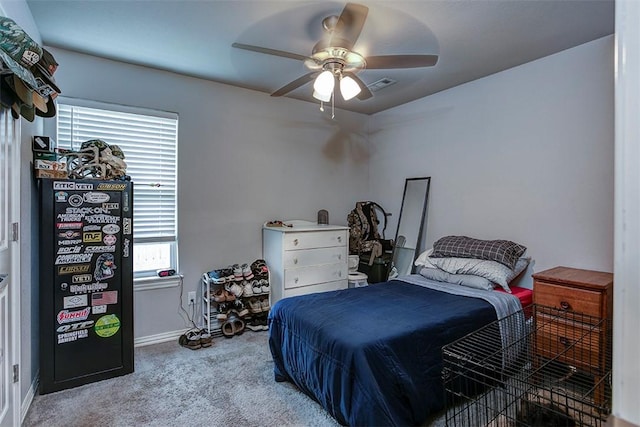 carpeted bedroom featuring baseboards and ceiling fan