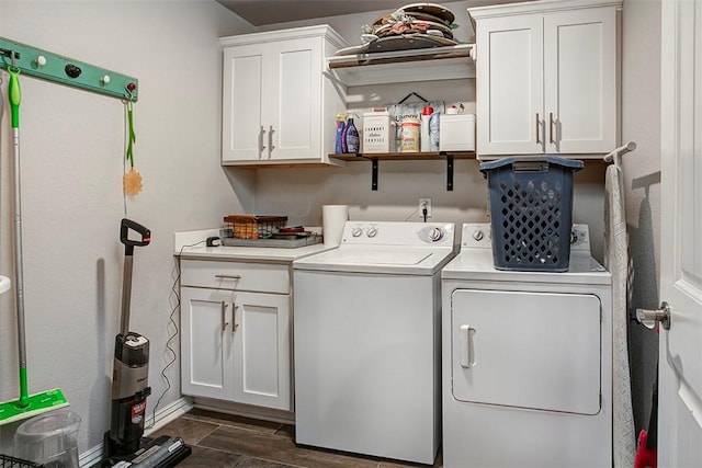 laundry room featuring washing machine and clothes dryer, cabinet space, and baseboards