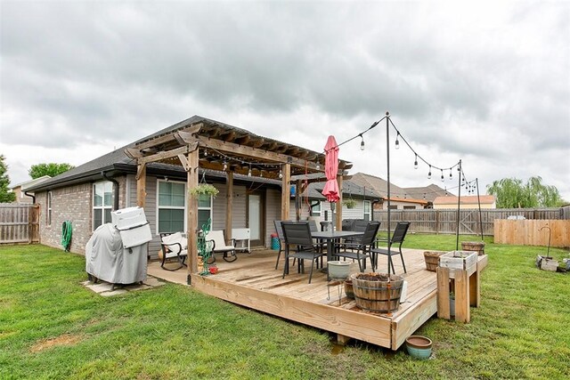 back of house with a wooden deck, a pergola, and outdoor dining space