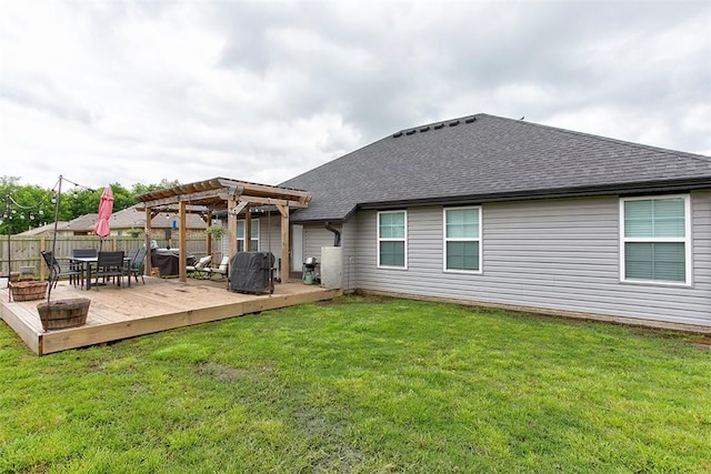 back of house with a pergola, a wooden deck, and a shingled roof