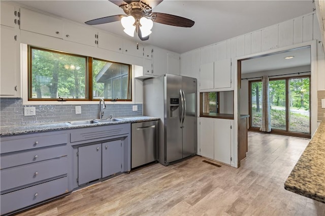13 Rancho Vista Ln, Holiday Island, AR 72631 - kitchen with stainless steel appliances, a sink, tasteful backsplash, a ceiling fan, and light wood-style floors