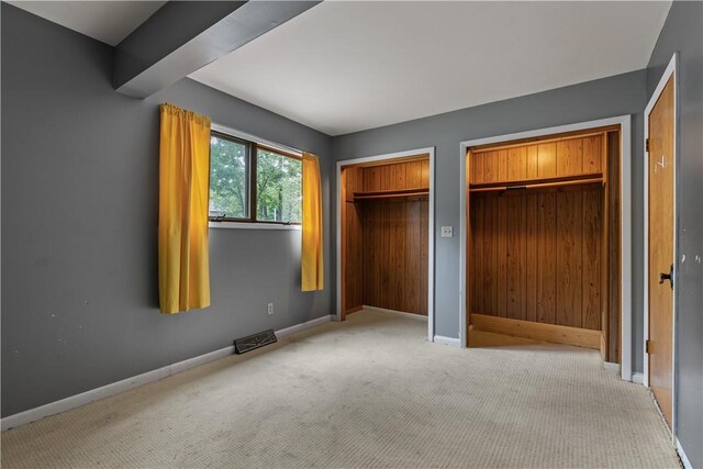 13 Rancho Vista Ln, Holiday Island, AR 72631 - unfurnished bedroom featuring multiple closets, carpet floors, and baseboards