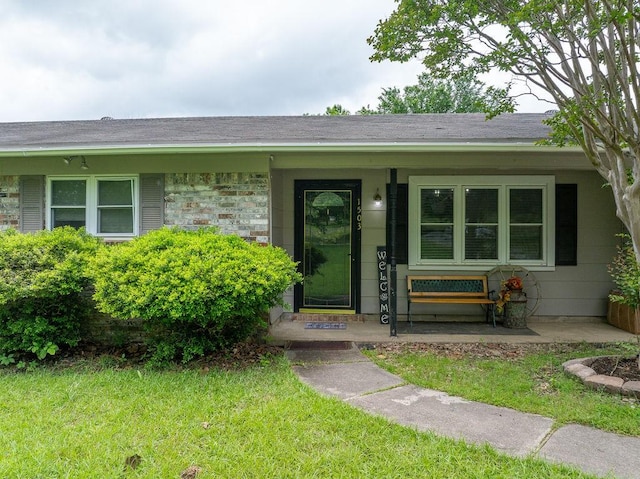 1503 Bugscuffle, Lavaca, AR 72941 - property entrance featuring a porch, a lawn, and a shingled roof