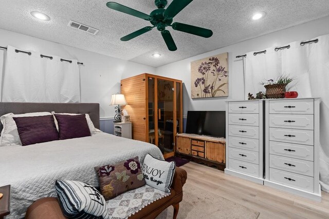 1503 Bugscuffle, Lavaca, AR 72941 - bedroom with light wood-type flooring, a textured ceiling, and ceiling fan