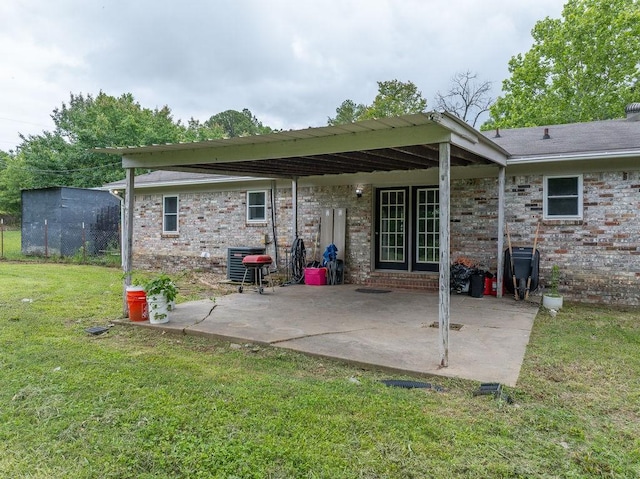 1503 Bugscuffle, Lavaca, AR 72941 - back of property featuring a yard, a patio area, brick siding, and central AC