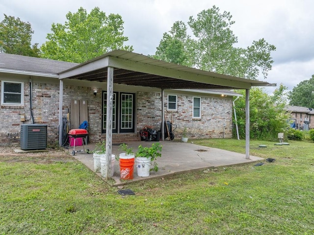 1503 Bugscuffle, Lavaca, AR 72941 - rear view of house featuring a lawn, a patio area, central air condition unit, and brick siding