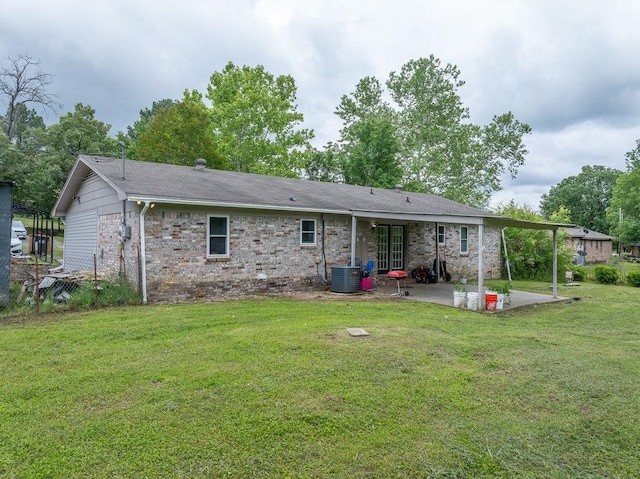 1503 Bugscuffle, Lavaca, AR 72941 - back of property with a patio area, a lawn, central AC, brick siding, and roof with shingles