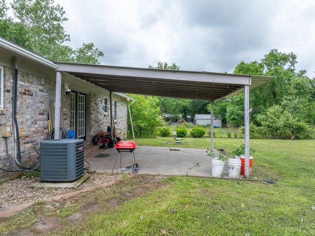1503 Bugscuffle, Lavaca, AR 72941 - view of grassy yard featuring cooling unit and a patio area