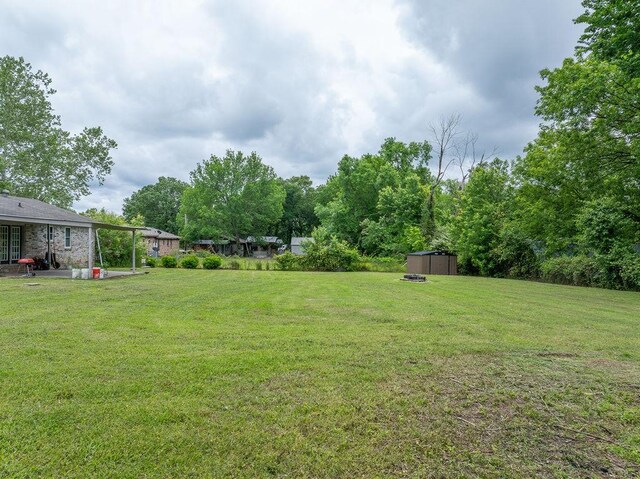 1503 Bugscuffle, Lavaca, AR 72941 - view of grassy yard featuring a shed, an outdoor structure, and a patio area