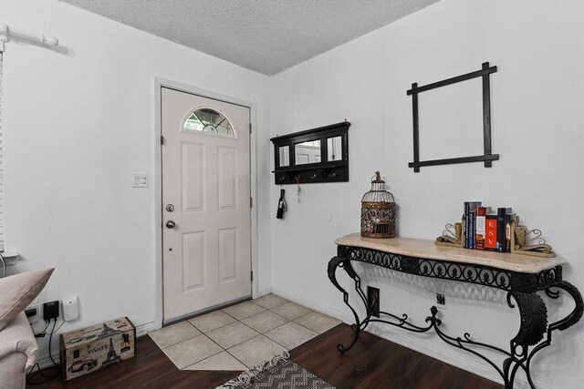 1503 Bugscuffle, Lavaca, AR 72941 - foyer with a textured ceiling, baseboards, and light tile patterned floors