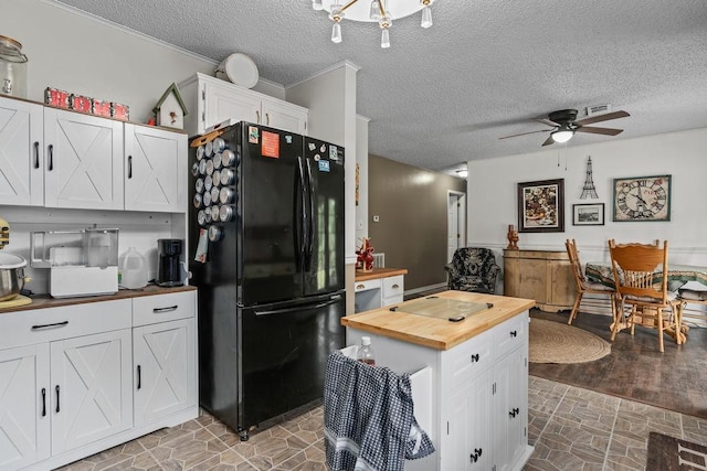 1503 Bugscuffle, Lavaca, AR 72941 - kitchen featuring freestanding refrigerator, wood counters, a ceiling fan, white cabinets, and a textured ceiling