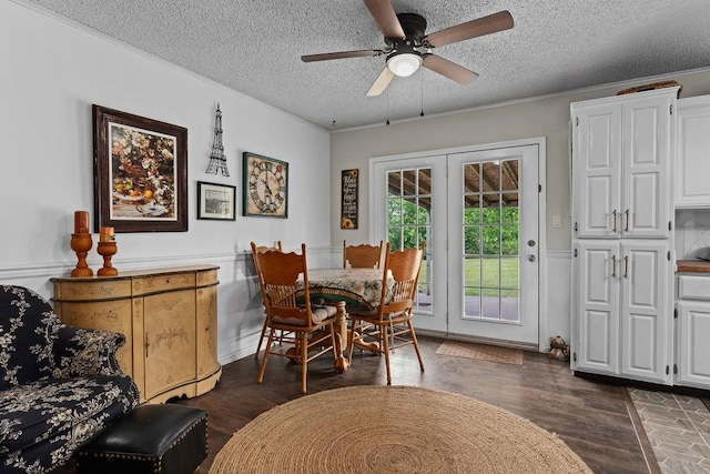 1503 Bugscuffle, Lavaca, AR 72941 - dining space featuring a textured ceiling, a ceiling fan, dark wood-style flooring, crown molding, and wainscoting