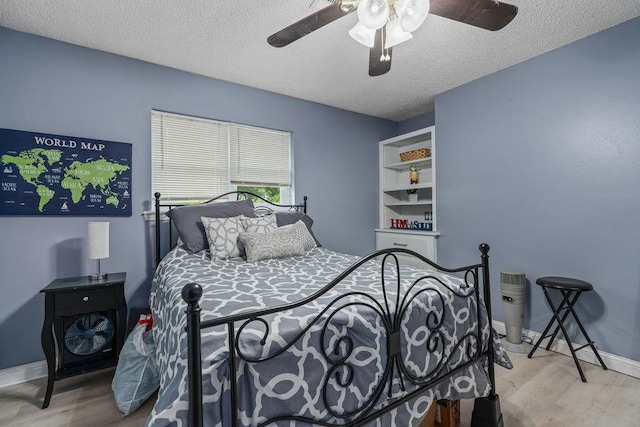 1503 Bugscuffle, Lavaca, AR 72941 - bedroom featuring wood finished floors, a textured ceiling, ceiling fan, and baseboards
