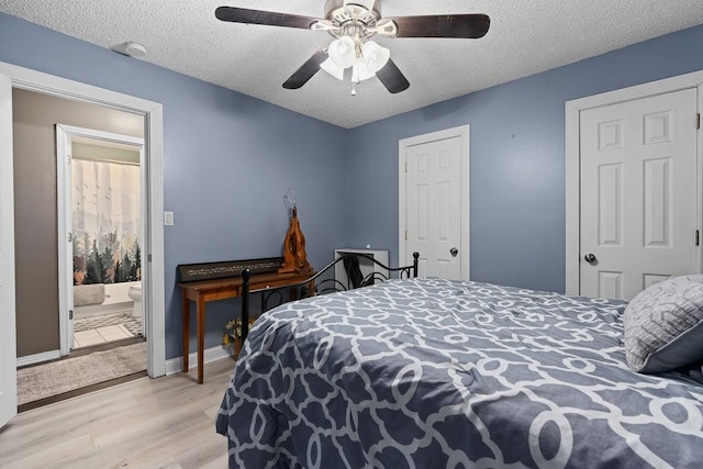 1503 Bugscuffle, Lavaca, AR 72941 - bedroom featuring light wood finished floors, a textured ceiling, a ceiling fan, and baseboards