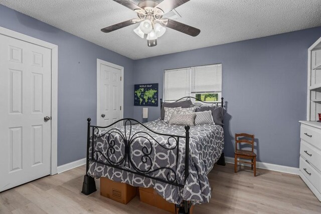 1503 Bugscuffle, Lavaca, AR 72941 - bedroom featuring light wood-style floors, baseboards, a textured ceiling, and ceiling fan