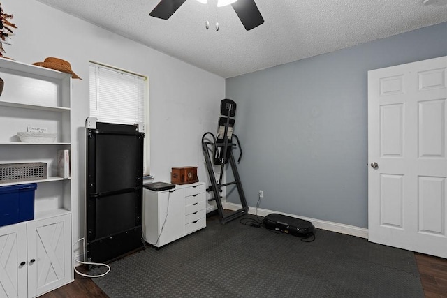 1503 Bugscuffle, Lavaca, AR 72941 - workout room featuring ceiling fan, a textured ceiling, baseboards, and dark wood finished floors
