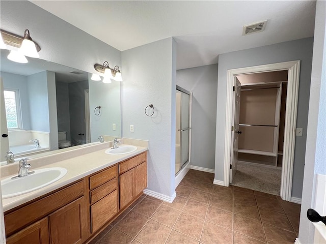 3703 Hansom Loop, Bentonville, AR 72712 - bathroom with a stall shower, a garden tub, tile patterned floors, baseboards, and double vanity