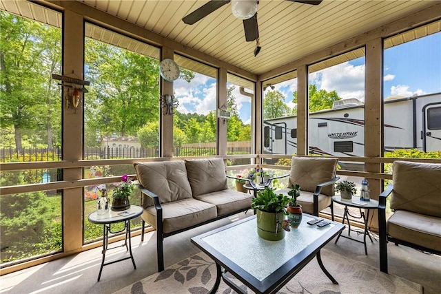 sunroom / solarium with a ceiling fan and outdoor lounge area