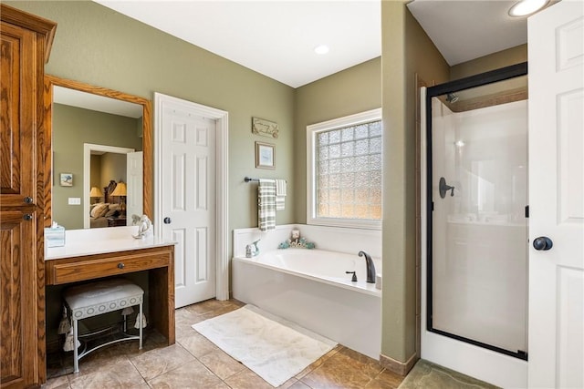 ensuite bathroom with a shower stall, a bath, and tile patterned flooring