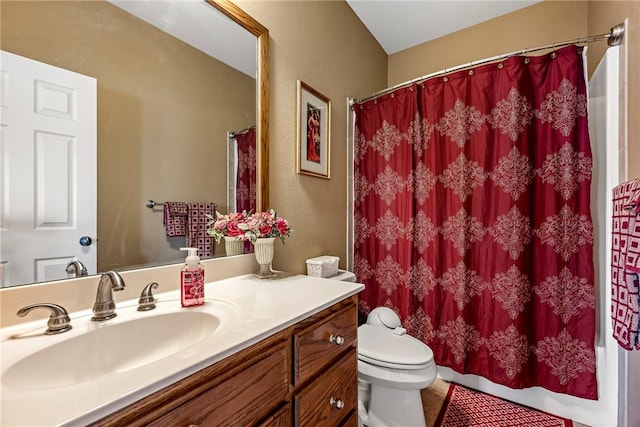 bathroom with vanity, toilet, and curtained shower