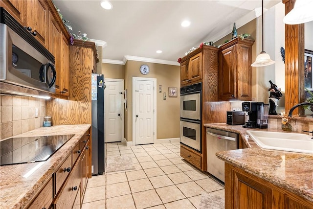 kitchen featuring appliances with stainless steel finishes, a sink, light tile patterned floors, crown molding, and decorative backsplash