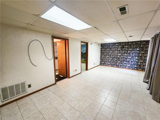 15043 Dutchmans Dr, Rogers, AR 72756 - finished below grade area with a drop ceiling, light tile patterned floors, and baseboards