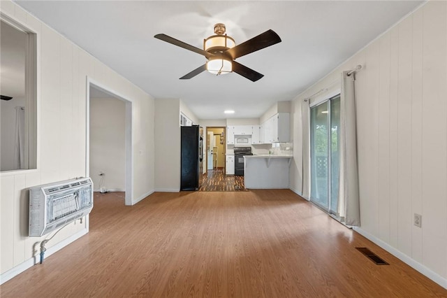 170 NC-8376, Jasper, AR 72641 - unfurnished living room with heating unit, light wood-style flooring, ceiling fan, and baseboards