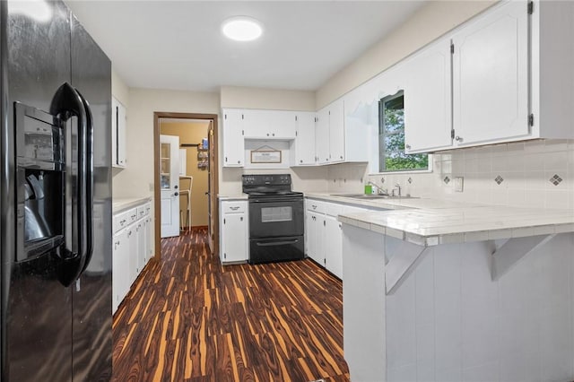 170 NC-8376, Jasper, AR 72641 - kitchen featuring black appliances, a sink, dark wood-style floors, a peninsula, and white cabinetry
