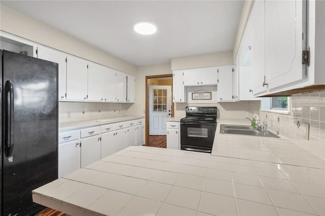 170 NC-8376, Jasper, AR 72641 - kitchen with black appliances, a sink, tasteful backsplash, and white cabinets