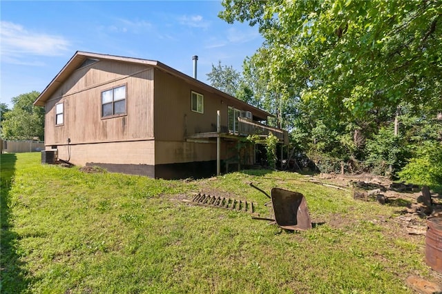 12508 Fords Rock Lndg, Lowell, AR 72745 - view of side of property featuring a lawn, central AC, and a deck