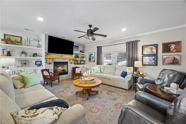 14156 Rolling Hills Dr, Bentonville, AR 72712 - living area featuring ornamental molding, a ceiling fan, wood finished floors, a stone fireplace, and recessed lighting