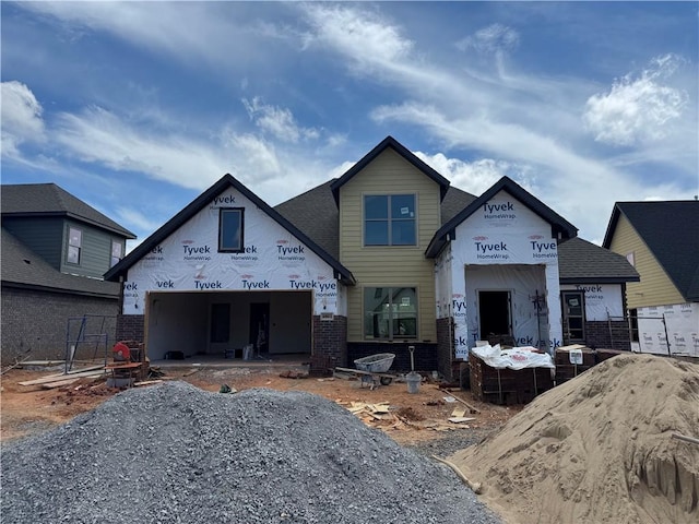 4801 SW Elderwood St, Bentonville, AR 72713 - property under construction featuring brick siding, driveway, and roof with shingles
