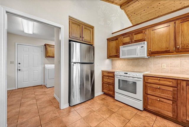 20916 Slate Gap Rd, Garfield, AR 72732 - kitchen with white appliances, washer / dryer, light tile patterned flooring, wood ceiling, and brown cabinets