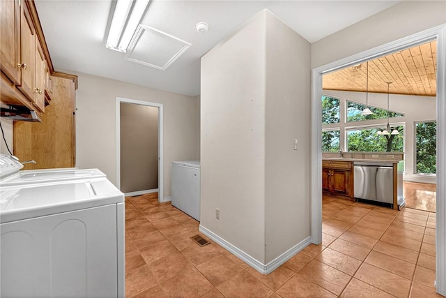 20916 Slate Gap Rd, Garfield, AR 72732 - laundry room featuring cabinet space, washer and clothes dryer, light tile patterned floors, attic access, and baseboards