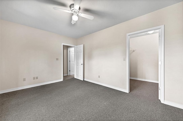 20916 Slate Gap Rd, Garfield, AR 72732 - unfurnished bedroom with a walk in closet, dark colored carpet, baseboards, a ceiling fan, and a closet