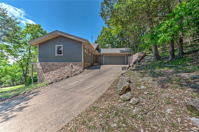 20916 Slate Gap Rd, Garfield, AR 72732 - view of front of home featuring stone siding, an attached garage, and concrete driveway