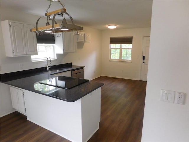 1411 Cresent St, Bentonville, AR 72712 - kitchen with a sink, dark countertops, black electric cooktop, and a peninsula