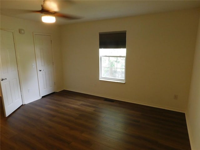 1411 Cresent St, Bentonville, AR 72712 - unfurnished bedroom with dark wood finished floors, baseboards, and a ceiling fan