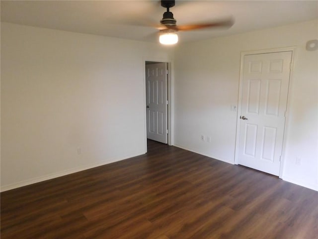 1411 Cresent St, Bentonville, AR 72712 - spare room with ceiling fan, dark wood-style flooring, and baseboards