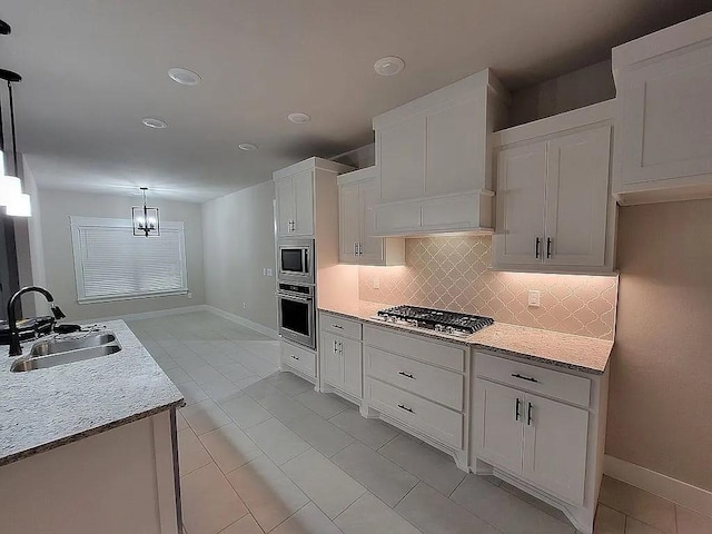 4202 SW Plumley Ave, Bentonville, AR 72713 - kitchen featuring a sink, appliances with stainless steel finishes, baseboards, decorative backsplash, and recessed lighting