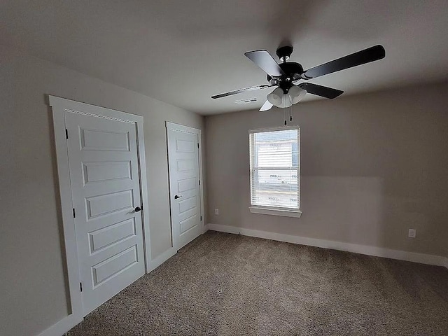 4202 SW Plumley Ave, Bentonville, AR 72713 - unfurnished bedroom featuring carpet, baseboards, and a ceiling fan