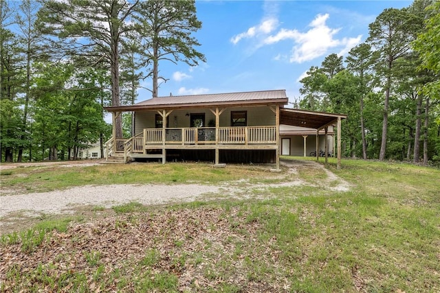 17278 Timberlake Trl, Rogers, AR 72756 - rear view of house with a metal roof, an attached carport, and a porch