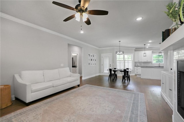 3 Francis Dr, Bella Vista, AR 72715 - living area with ceiling fan, dark wood-type flooring, ornamental molding, recessed lighting, and baseboards