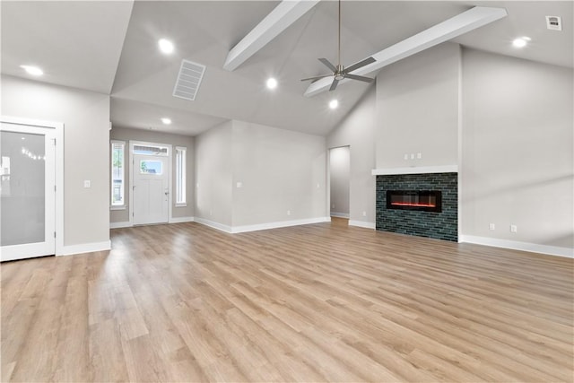 unfurnished living room featuring high vaulted ceiling, ceiling fan, baseboards, light wood-style floors, and a glass covered fireplace